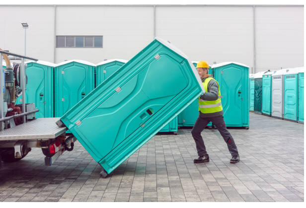 Crew delivering a portable toilet unit